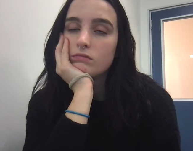 A tired student fighting sleep in class