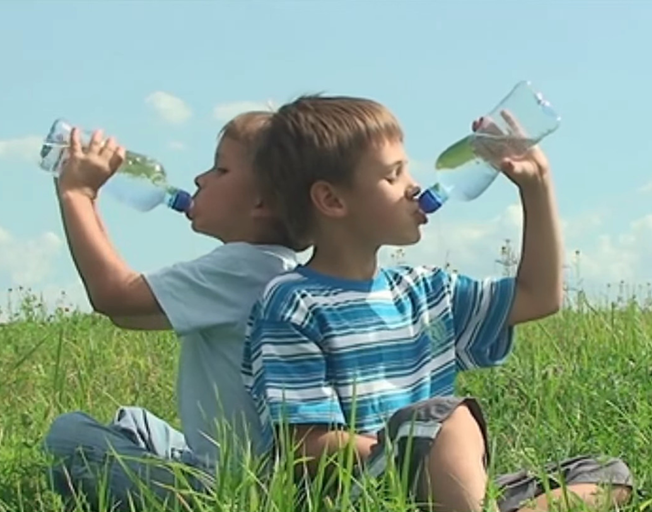 Two Kids Drinking From Water Bottles