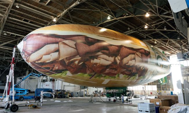 Subway blimp being prepared in hanger