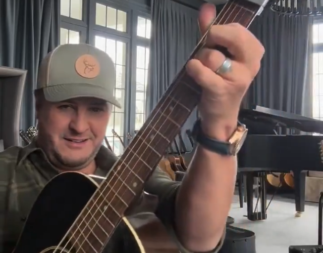 Luke Bryan playing a guitar