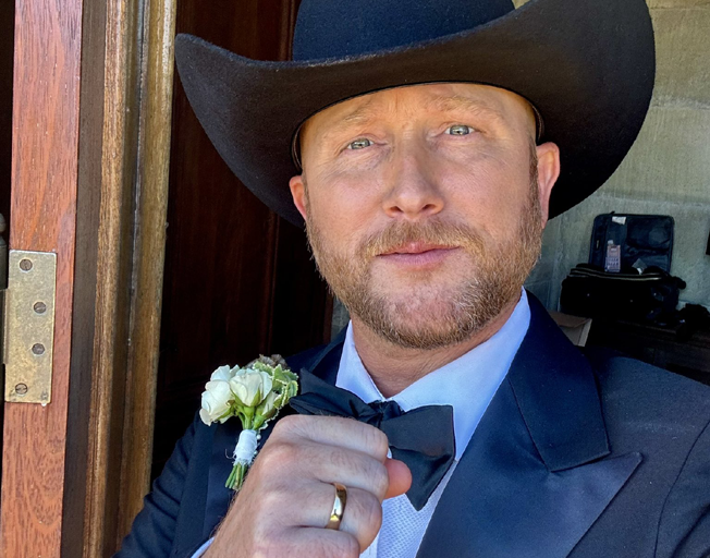 Cole Swindell showing his wedding ring on his wedding day 06-12-24