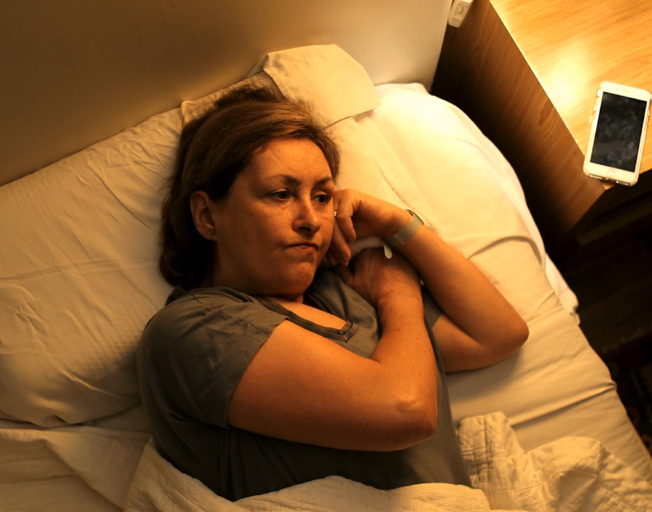 A person lying awake in bed