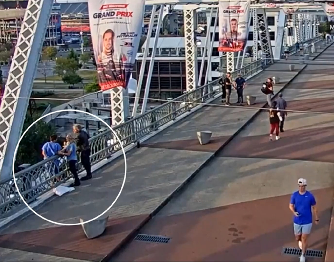 Security video if Jon Bon Jovi and a member of his team talking to a woman on the ledge of a bridge